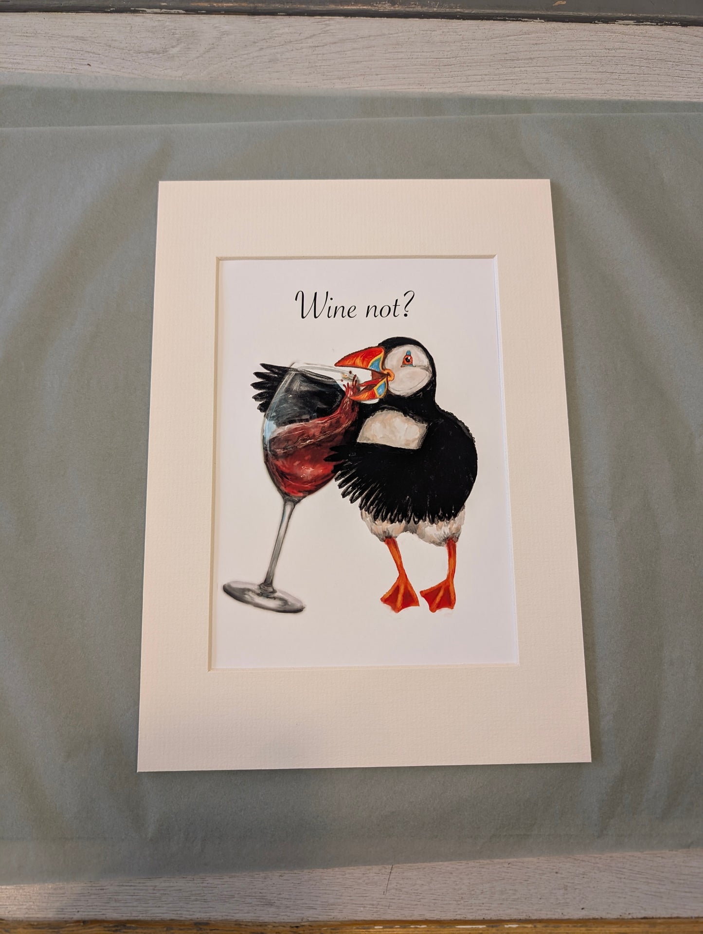 Mixed media art print of a puffin sipping red wine, illustrated in watercolour, gouache, and digital, titled âWine not?â