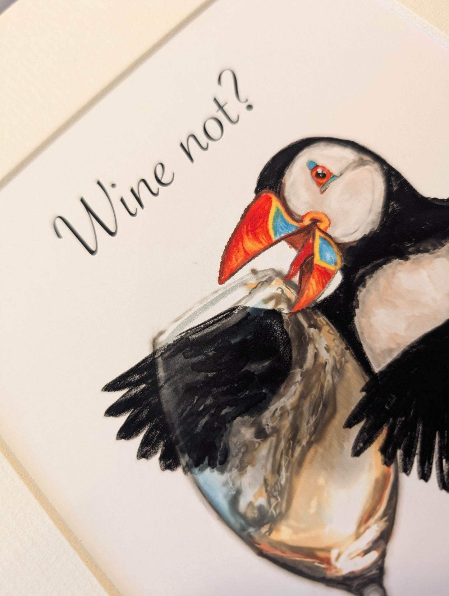 Close-up of puffin illustration showing texture of watercolour and gouache in white wine glass.